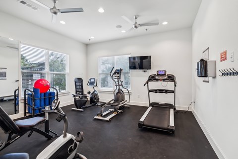 the gym with treadmills and exercise equipment at 1861 muleshoe road apartments